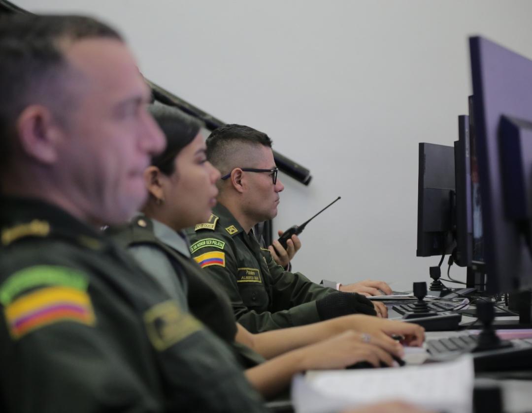 Policias en la sala de monitoreo observando las cámaras de seguridad